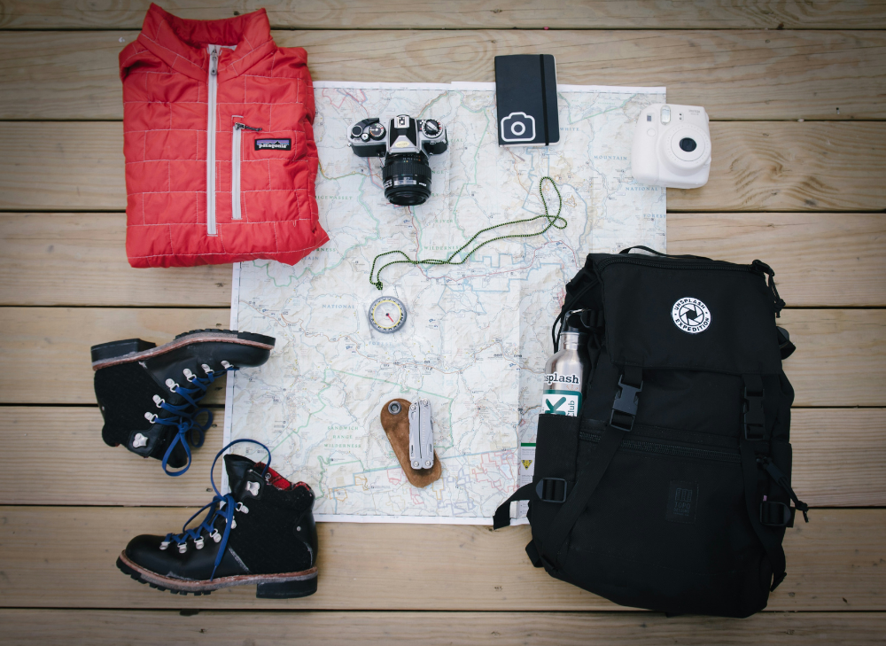 a back pack, map, and travel items