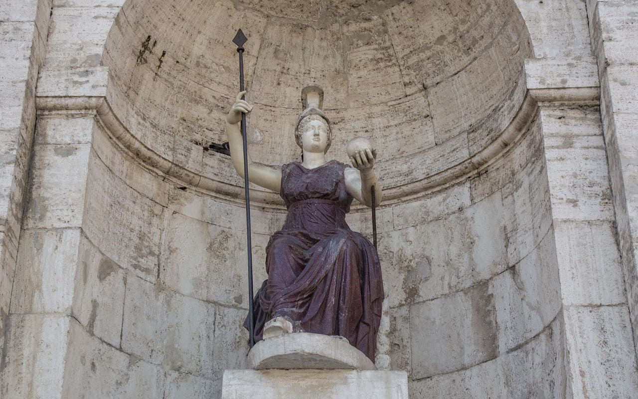 a statue of a sitting woman making a fashion statement with a dark dress in italy