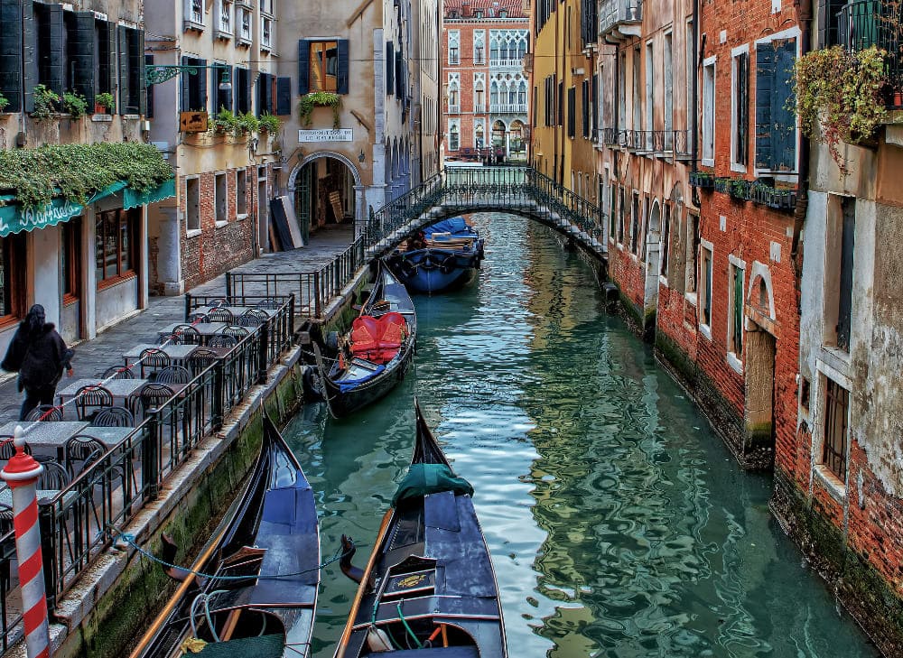 a waterway in venice shown with gondolas